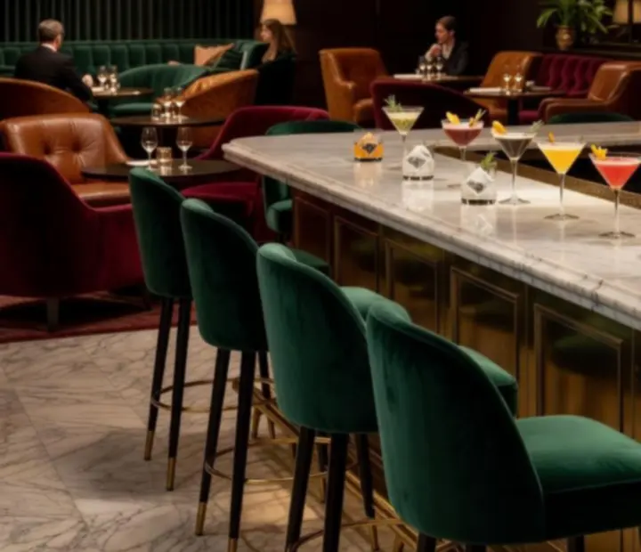 Bar and lounge area at Dewesoft Hungary Korlátolt Felelősségű Társaság with bronze lighting and forest green details
