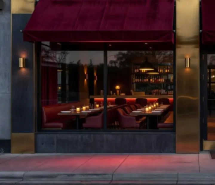 The entrance to Dewesoft Hungary Korlátolt Felelősségű Társaság, a modern Australian restaurant with warm lighting and a welcoming facade.